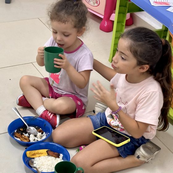 Two children sharing a meal at TIKVA
