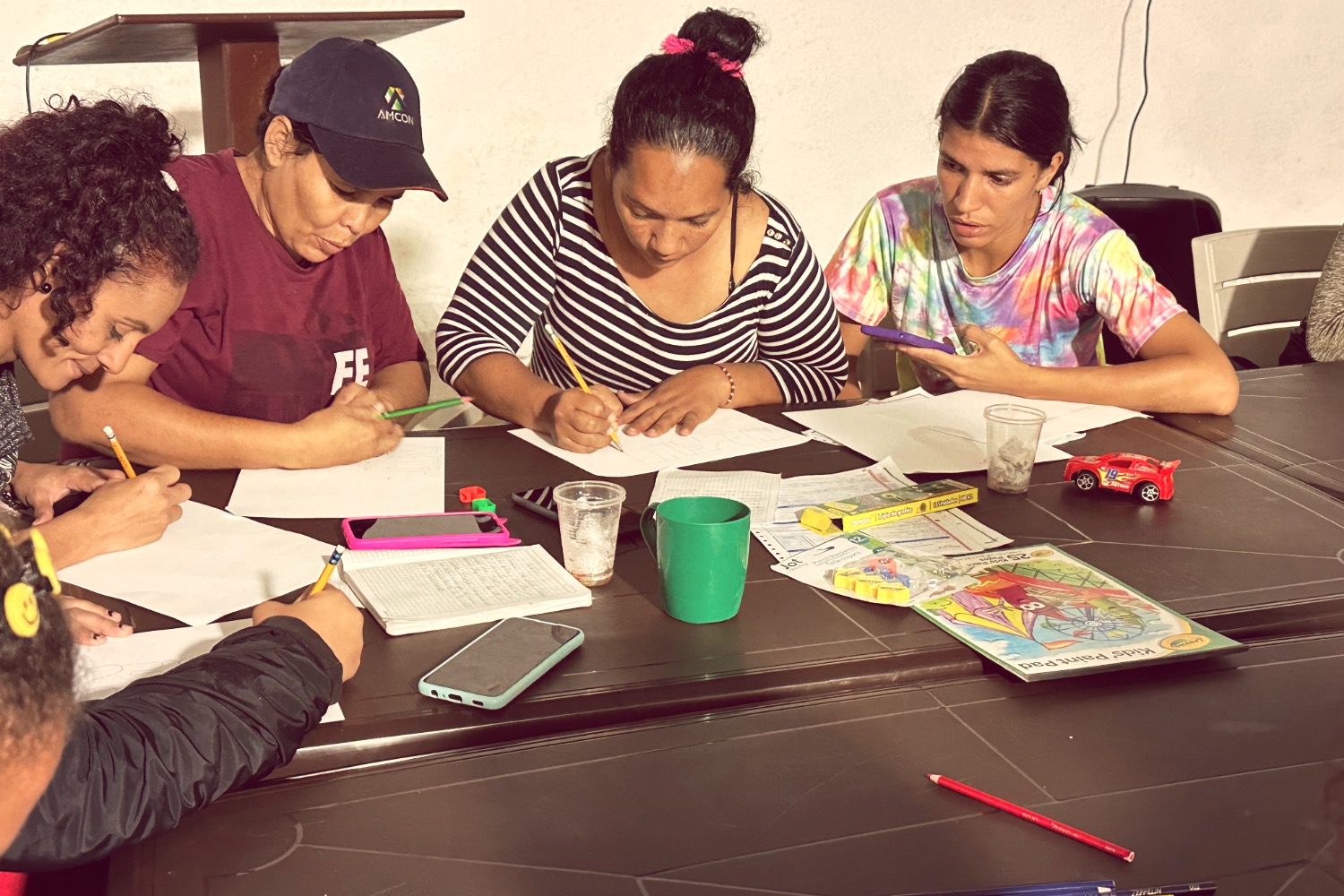 People at a concert facing the stage with various colours of paint powder in the air