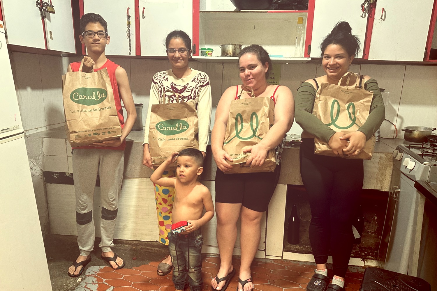 DJ facing a crowd at his deck. Photo with a purple hue